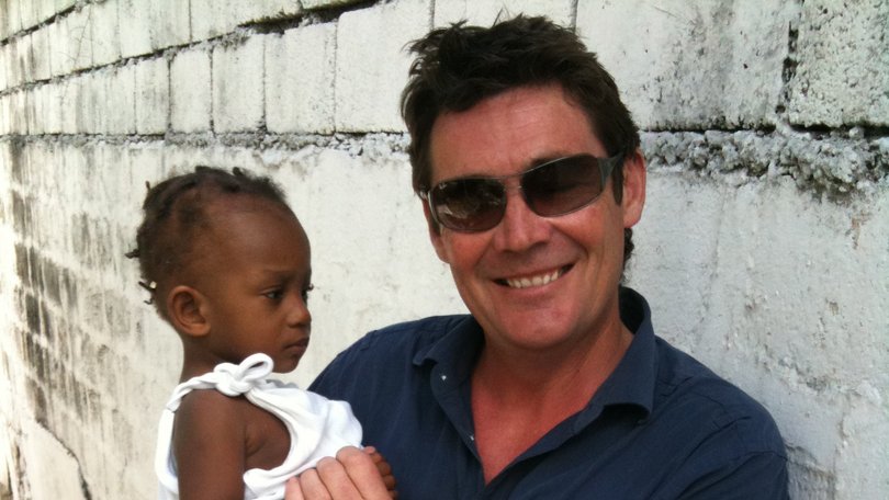 Mike Amor with rescued baby Winnie, who spent three days buried under rubble following the 2010 Haiti earthquake.