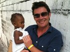 Mike Amor with rescued baby Winnie, who spent three days buried under rubble following the 2010 Haiti earthquake.