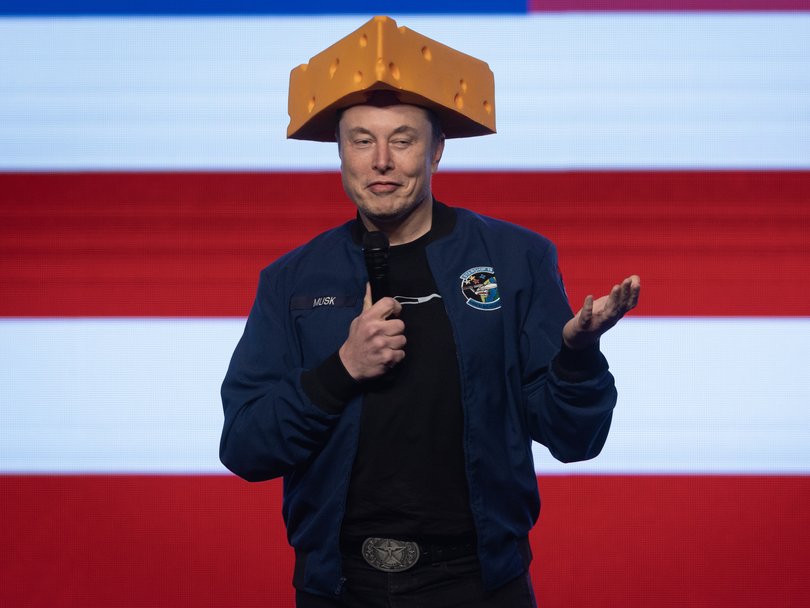 Elon Musk arrives for a town hall wearing a cheesehead hat at the KI Convention Center on March 30, 2025 in Green Bay, Wisconsin.