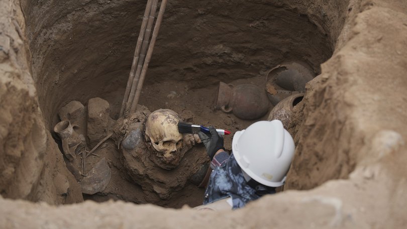 Archaeologist Jose Aliaga works at the site where city workers discovered ancient remains, from the pre-Inca Chancay culture.