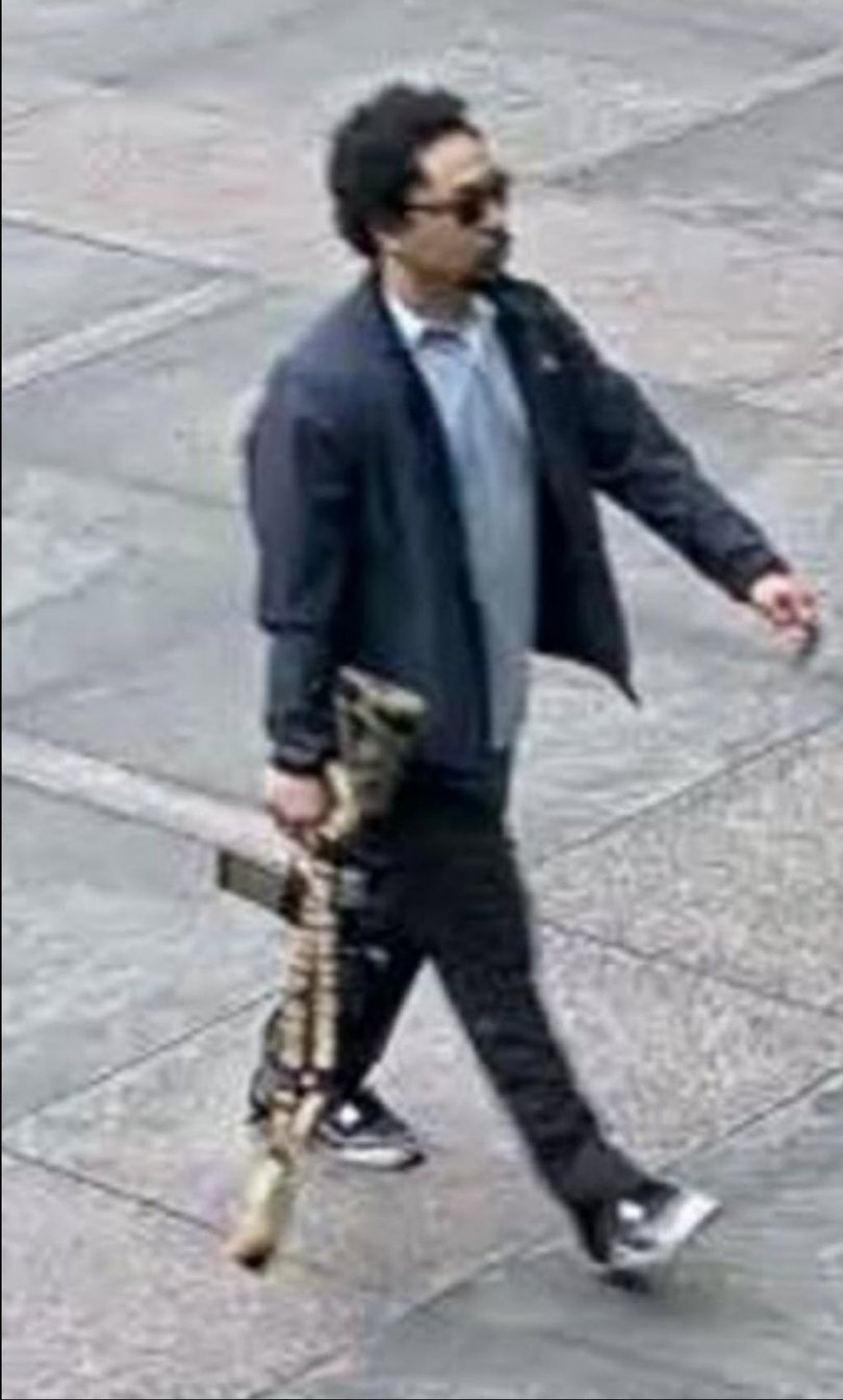 The shooter is seen entering the Manhattan building with a rifle.