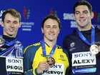 Australia's Cam McEvoy shows off his 50m freestyle gold medal at the world titles in Singapore. (AP PHOTO)