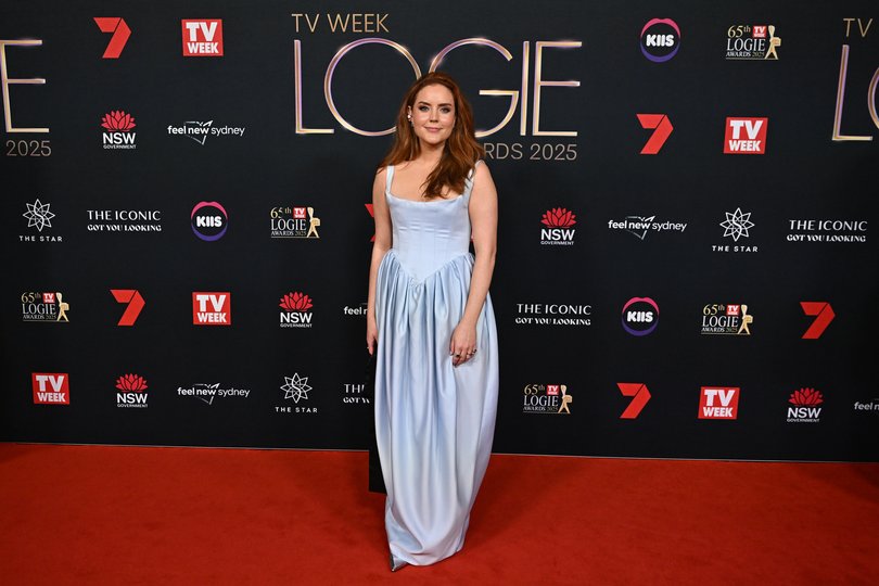Georgie Tunny arrives in a simple silver number.