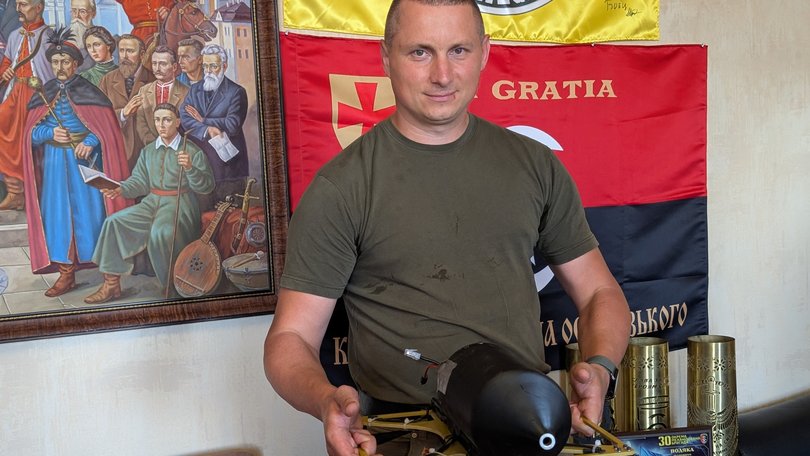 Artur Zahryviy, 38, head of Zviahel’s local district government council, holds a Russian FPV drone.