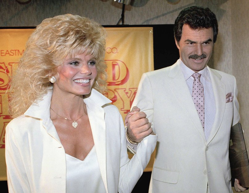 Burt Reynolds, right, holds hands with Loni Anderson in 1987, in Los Angeles.