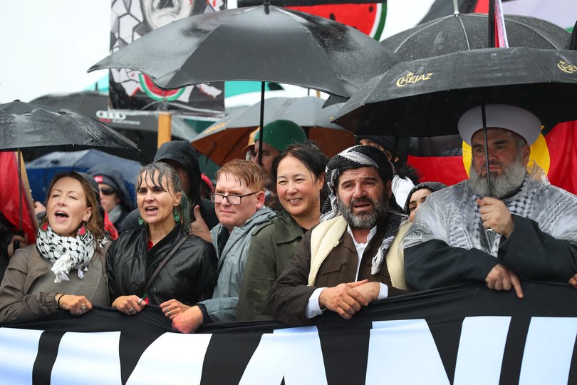 Protesters march in the rain across the Harbour Bridge during the pro-Palestinian rally in Sydney.