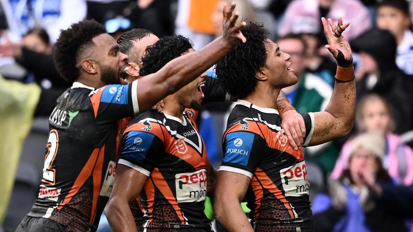 Tigers players appeared to taunt Bulldogs fans with the "khod" gesture after their victory. (Dan Himbrechts/AAP PHOTOS)