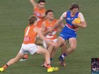 Young Bulldog key defender Jedd Busslinger being tackled by GWS Giant Jake Riccardi.