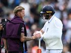Chris Woakes of England shakes hands with Ben Stokes after play on day five.