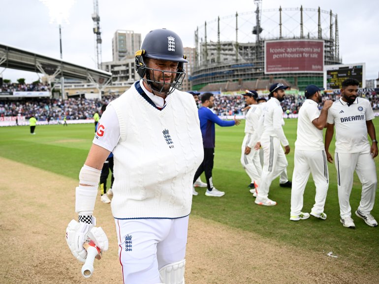 Chris Woakes of England walks off the field at the end of the match after batting with his arm in a sling on day five.
