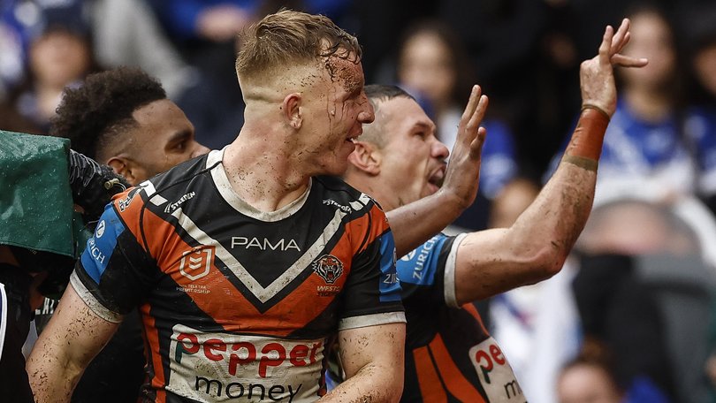 Brent Naden, right, celebrates a Tigers try during the round 22 match. He is set to be fined for the gesture.