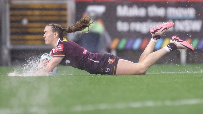 Tamika Upton of the Broncos scores a try in the horrific conditions.