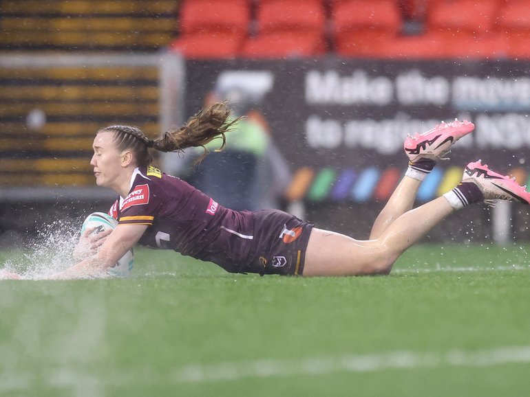 Tamika Upton of the Broncos scores a try in the horrific conditions. 