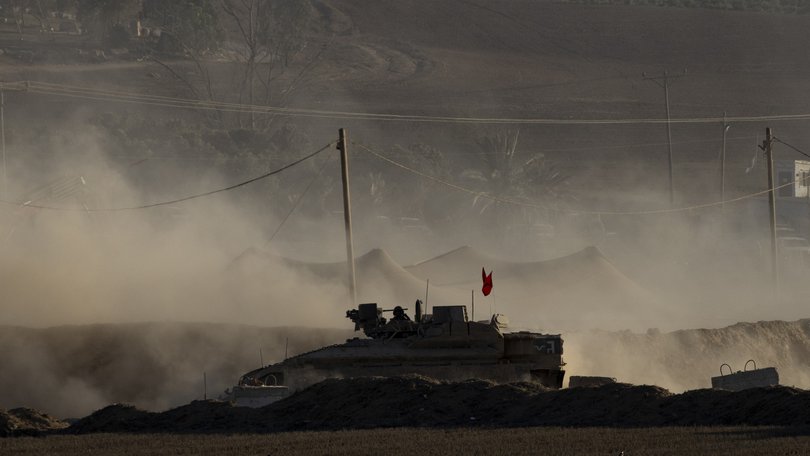 An Israeli armoured personnel carrier moves near the border with the Gaza Strip.