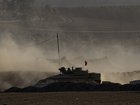 An Israeli armoured personnel carrier moves near the border with the Gaza Strip.