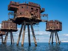 The rusting remains of the Maunsell Forts are seen close to the shore at Whitstable off the east coast of England.