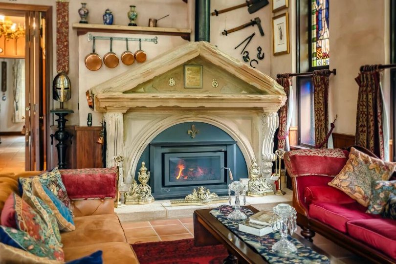 The living room features a grand fireplace.
