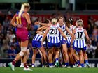 Kangaroos players celebrate victory on the final siren of the AFLW grand final at Ikon Park.