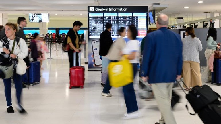 Sydney Airport has been placed into lockdown after a person attempted to take a weapon from an Australian Federal Police officer, 2GB reports.