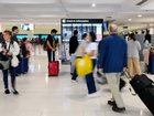 Sydney Airport has been placed into lockdown after a person attempted to take a weapon from an Australian Federal Police officer, 2GB reports.