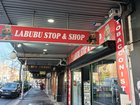 Signage at Labubu Stop & Shop showing Labubu toys with a vape in front.