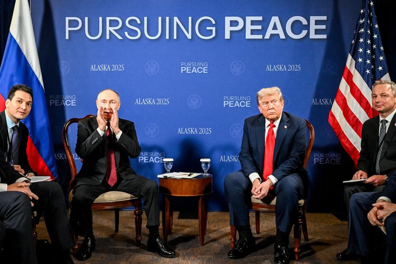 Vladimir Putin shouts something as he meets US President Donald Trump at Joint Base Elmendorf-Richardson. 