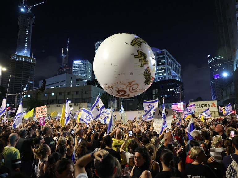 Protesters supporting the families of Israeli hostages held by Hamas in Gaza take part in  a nationwide strike protest in Tel Aviv.