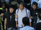 Hong Kong media magnate Jimmy Lai, centre, being taken away by police officers outside government headquarters in Hong Kong in 2014.