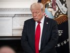 President Donald Trump prays as he takes part in the White House Faith Office luncheon in the White House in July.
