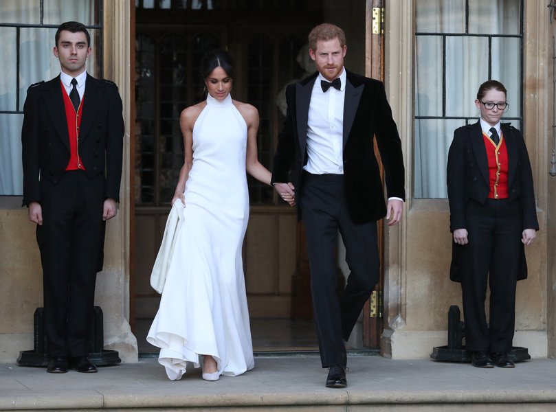 The Duke and Duchess of Sussex wave as they leave Windsor Castle after their wedding.