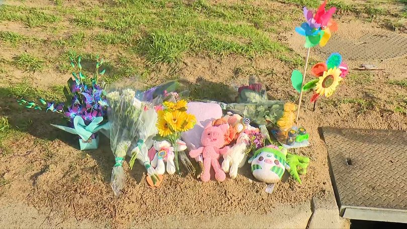 Flowers and toys have been left at the scene where the newborn was found.