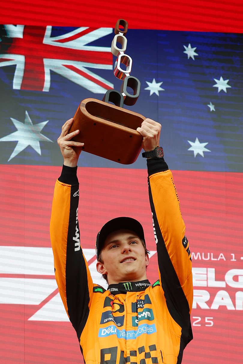 Race winner Oscar Piastri of Australia and McLaren celebrates on the podium during the F1 Grand Prix of Belgium at Circuit de Spa-Francorchamps.