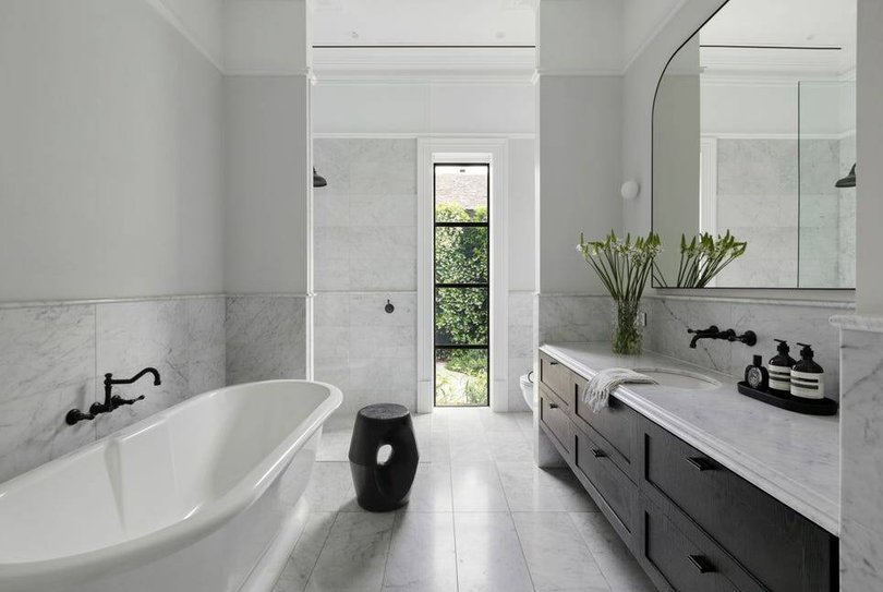 The bathroom features marble finsihes.