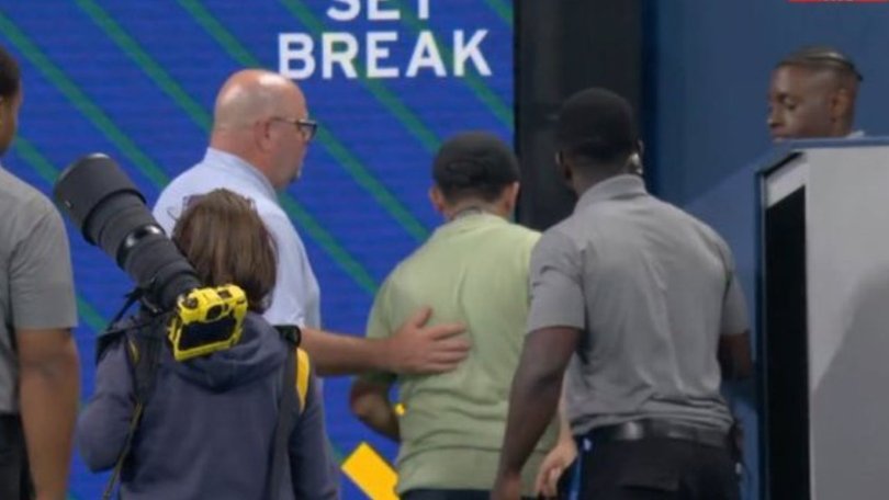 The photographer was escorted off the court.