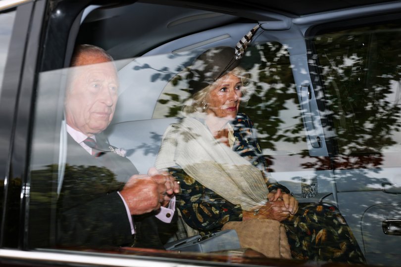 King Charles III and Queen Camilla arrive by car at Crathie Kirk.