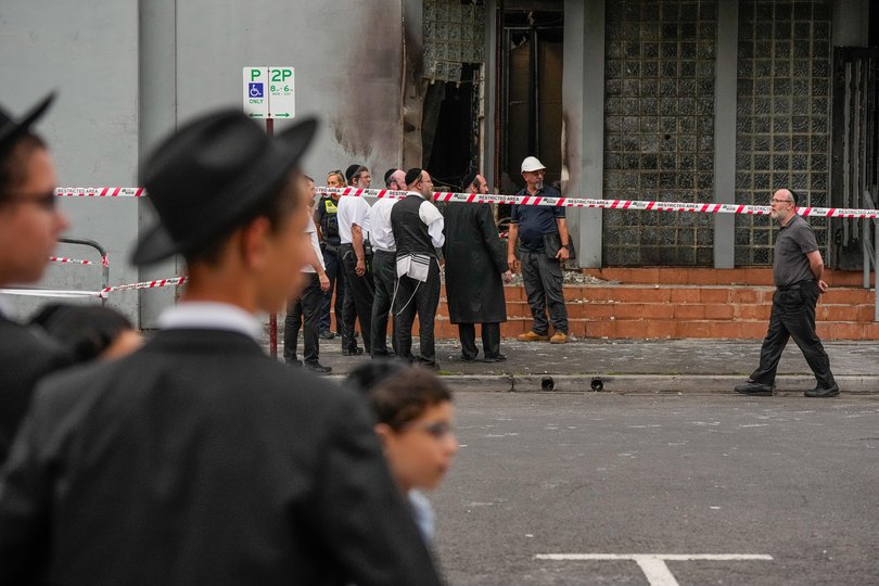 Members of the local Jewish community look at the damage of the arson attack at the Adass Israel Synagogue on December 06, 2024 in Melbourne, Australia.