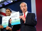 Former Reform chairman Zia Yusuf and Reform UK Leader Nigel Farage,  hold up signed copies of their new policy.