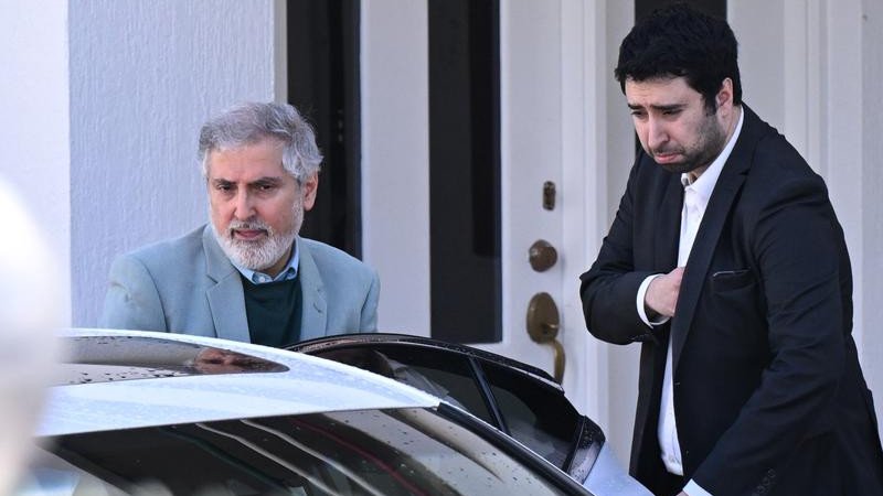 Iranian ambassador to Australia Ahmad Sadeghi (left) leaves the embassy in Canberra.
