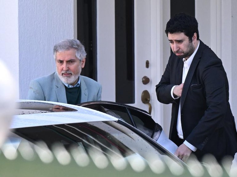 Iranian ambassador to Australia Ahmad Sadeghi (left) leaves the embassy in Canberra.