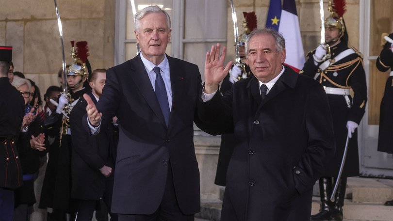 France's outgoing Prime Minister Michel Barnier, left, and France's newly appointed Prime Minister Francois Bayrou in December 2024.