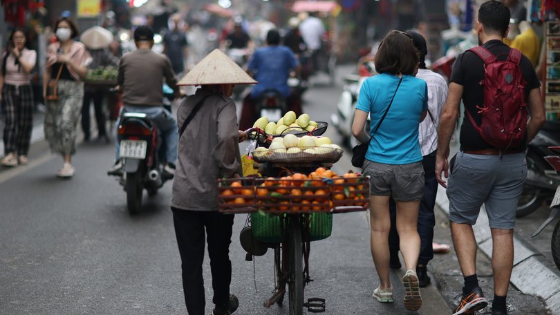 HANOI, VIETNAM - APRIL 12: A vendor wheels a bicycle loaded with fruits on the street on April 12, 2025 in Hanoi, Vietnam. Vietnam will be the first stop of Chinese President Xi Jinping's upcoming state visits to three Southeast Asian countries. (Photo by Sheng Jiapeng/China News Service/VCG via Getty Images)