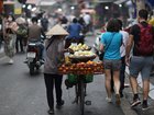 HANOI, VIETNAM - APRIL 12: A vendor wheels a bicycle loaded with fruits on the street on April 12, 2025 in Hanoi, Vietnam. Vietnam will be the first stop of Chinese President Xi Jinping's upcoming state visits to three Southeast Asian countries. (Photo by Sheng Jiapeng/China News Service/VCG via Getty Images)