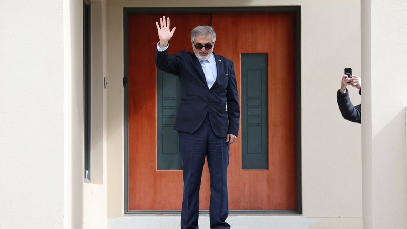 Iranian ambassador to Australia Ahmad Sadeghi waves outside his residence, after being expelled on Tuesday.