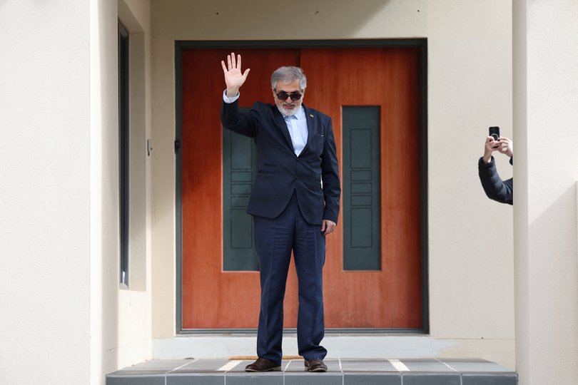 Iranian ambassador to Australia Ahmad Sadeghi waves outside his residence, after being expelled on Tuesday.