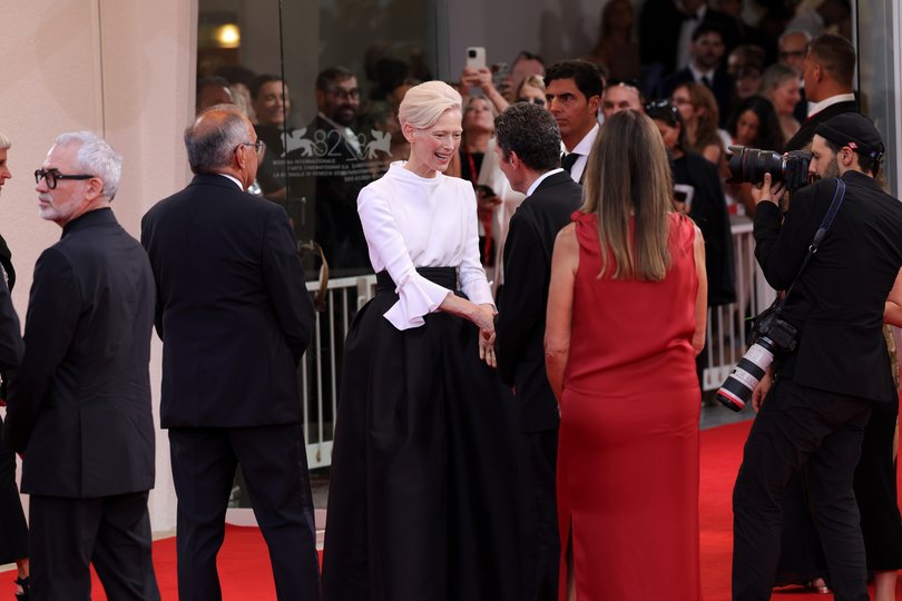 Tilda Swinton meets a pal on the red carpet at Venice