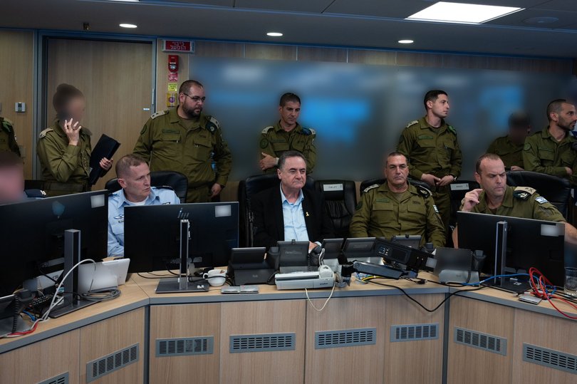 Israel Katz sat beside military officials.