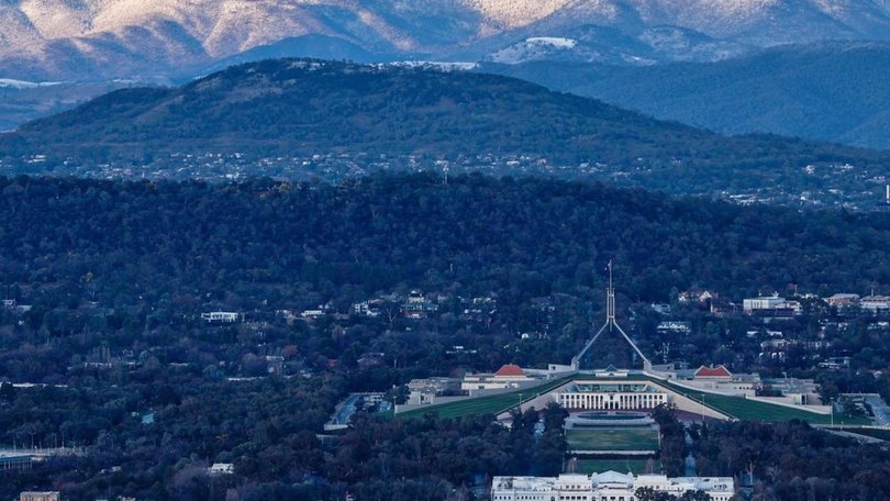 The Brindabella Range behind Parliament House in snow.