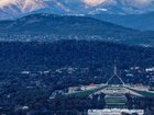 The Brindabella Range behind Parliament House in snow. 