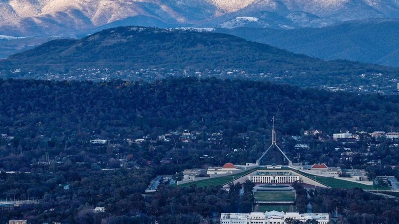 The Brindabella Range behind Parliament House in snow. Picture: Calvin Lau