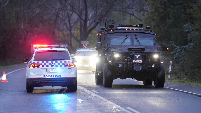 Police continue to search the alpine terrain for an armed fugitive who allegedly killed two officers.